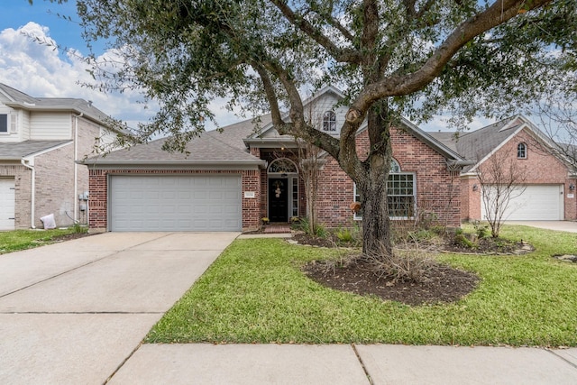 view of front facade with concrete driveway, a garage, brick siding, and a front yard