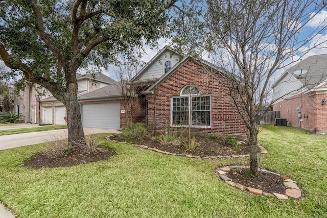 traditional-style house featuring brick siding, concrete driveway, central AC, a front yard, and a garage