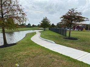 surrounding community featuring a yard and a water view