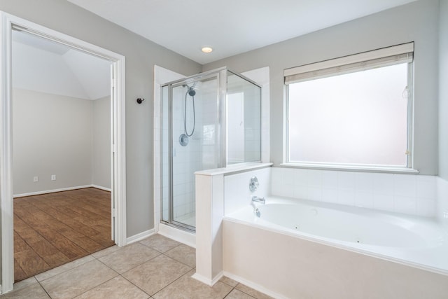 full bath featuring tile patterned floors, a whirlpool tub, and a shower stall