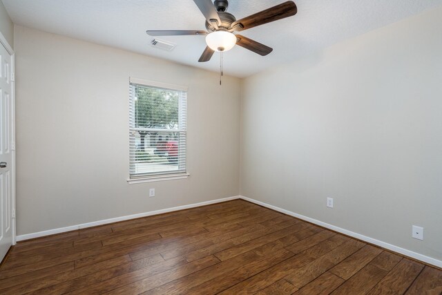 spare room featuring visible vents, baseboards, and hardwood / wood-style flooring