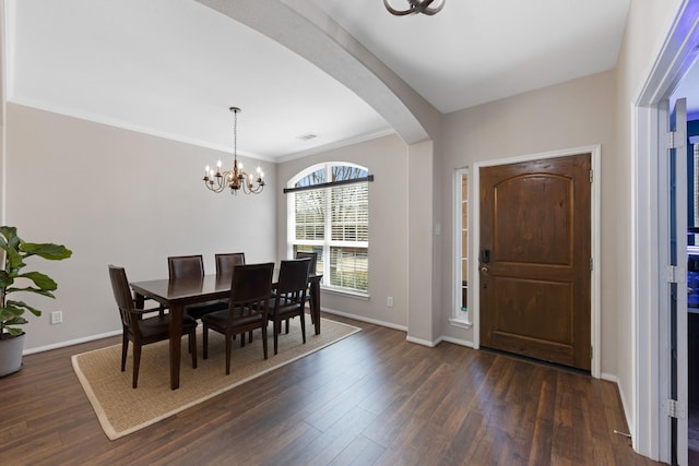 dining space with dark wood-style flooring, baseboards, and an inviting chandelier