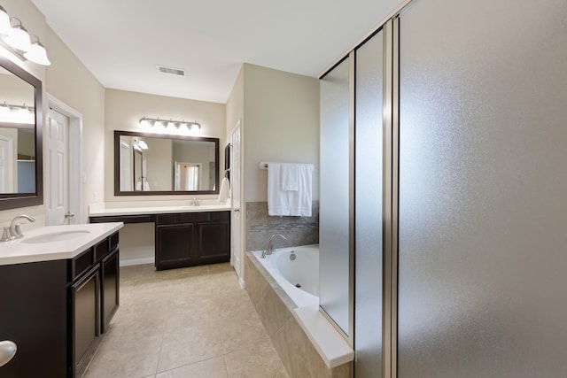 bathroom featuring tile patterned flooring, two vanities, a sink, visible vents, and a bath