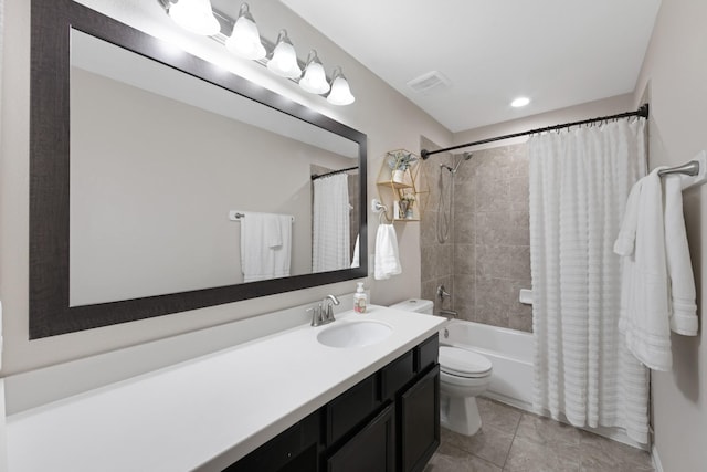 full bath featuring visible vents, toilet, tile patterned flooring, shower / bath combo with shower curtain, and vanity