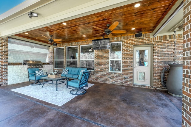 view of patio / terrace featuring a ceiling fan, an outdoor living space, and grilling area