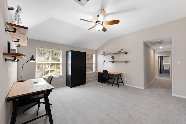 carpeted home office with a ceiling fan, lofted ceiling, visible vents, and baseboards