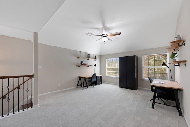 carpeted office space featuring ceiling fan, vaulted ceiling, and baseboards