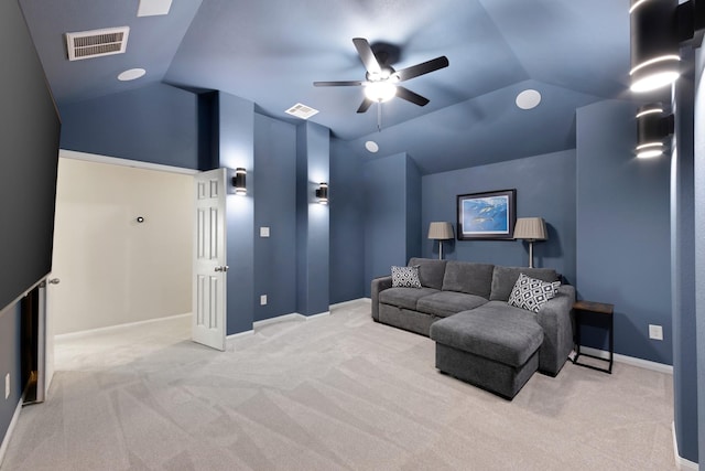 home theater room with lofted ceiling, visible vents, and baseboards