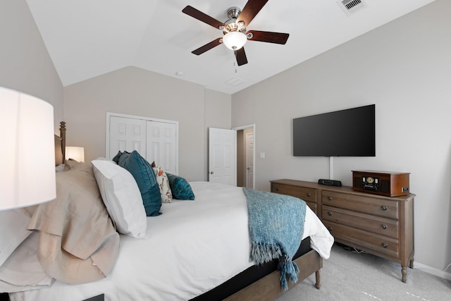 bedroom with ceiling fan, light carpet, visible vents, vaulted ceiling, and a closet