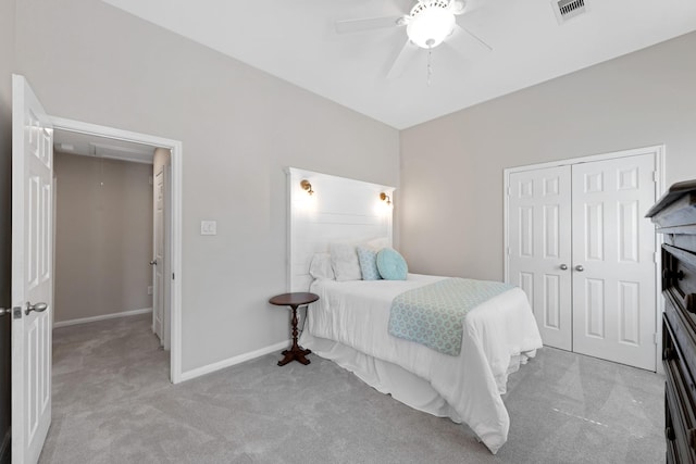 carpeted bedroom featuring attic access, baseboards, visible vents, ceiling fan, and a closet