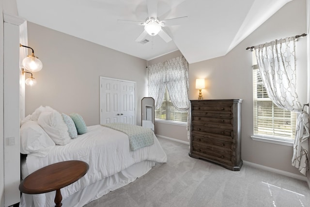 bedroom with light carpet, multiple windows, a closet, and visible vents