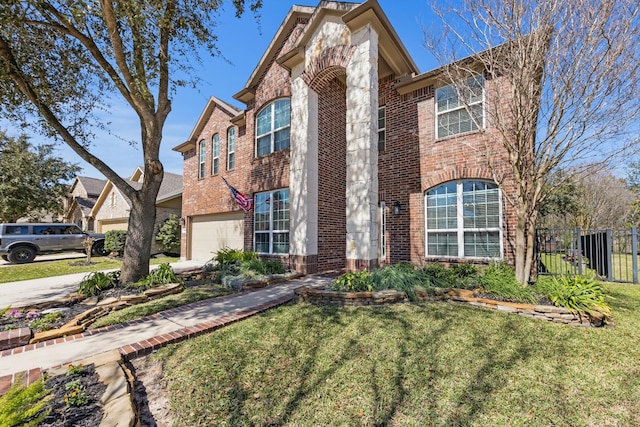 view of front of property with brick siding, concrete driveway, a front yard, fence, and a garage