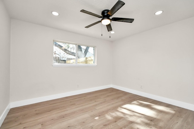 unfurnished room featuring baseboards, wood finished floors, and recessed lighting