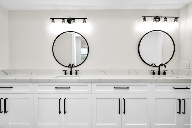 full bathroom featuring a sink and double vanity