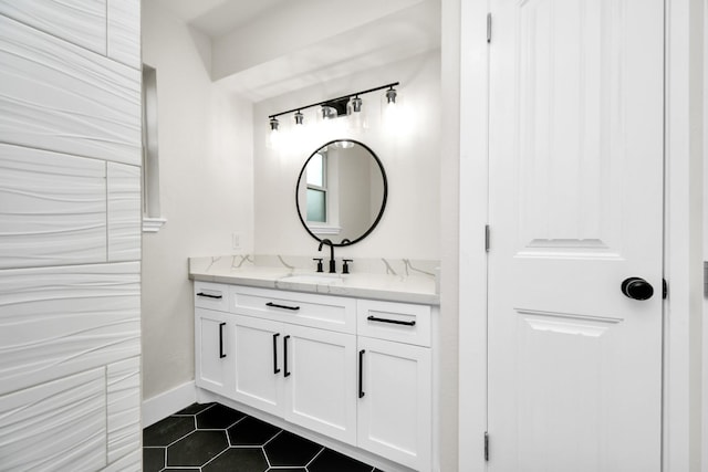 bathroom featuring vanity, baseboards, and tile patterned floors