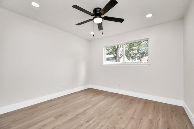 spare room with recessed lighting, wood finished floors, a ceiling fan, and baseboards