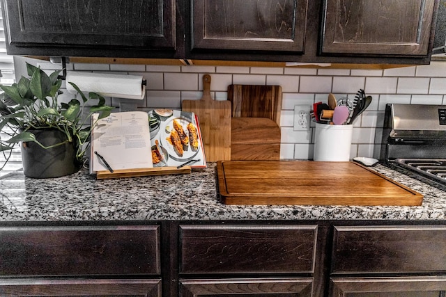 room details with dark countertops, dark brown cabinetry, and backsplash