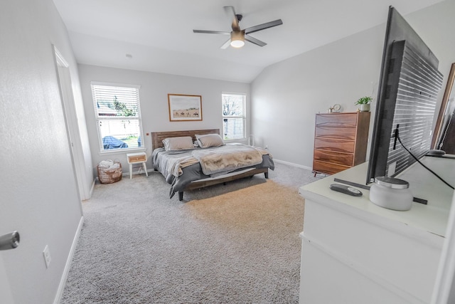 bedroom featuring light carpet, baseboards, a ceiling fan, and lofted ceiling