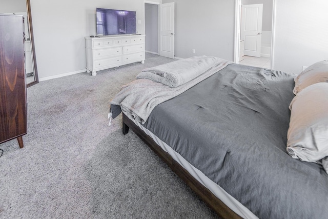 bedroom with baseboards and light colored carpet