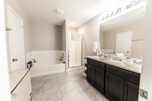 full bath with a garden tub, double vanity, a sink, a shower stall, and tile patterned floors