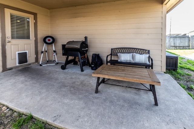 view of patio featuring fence and area for grilling