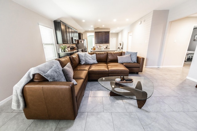 living area with recessed lighting, light tile patterned flooring, and baseboards