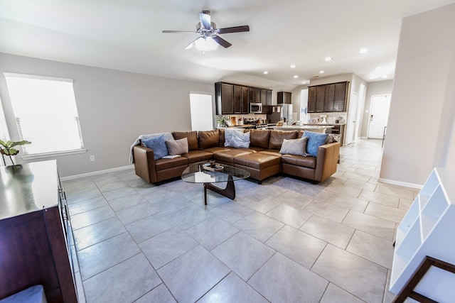 living room with light tile patterned floors, baseboards, a ceiling fan, and recessed lighting