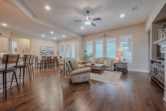 living area with dark wood-style floors, recessed lighting, visible vents, and baseboards