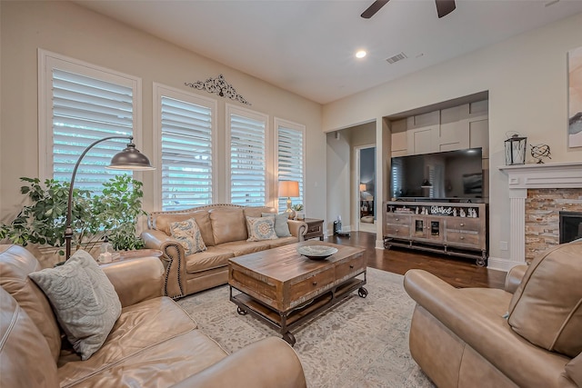 living room featuring visible vents, a ceiling fan, wood finished floors, a stone fireplace, and recessed lighting