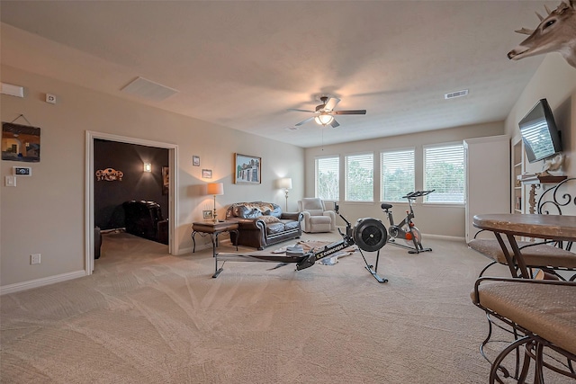 living room featuring baseboards, visible vents, and light colored carpet