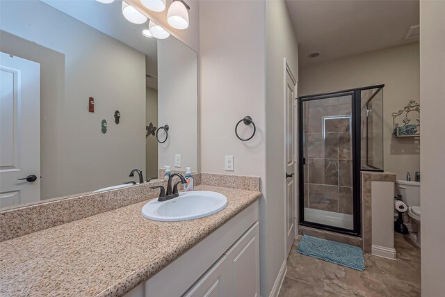 full bath with toilet, a stall shower, and vanity