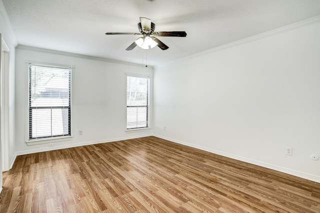 unfurnished room featuring ceiling fan, ornamental molding, light wood-style flooring, and baseboards