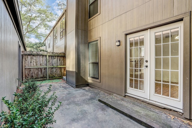 property entrance featuring fence and a patio