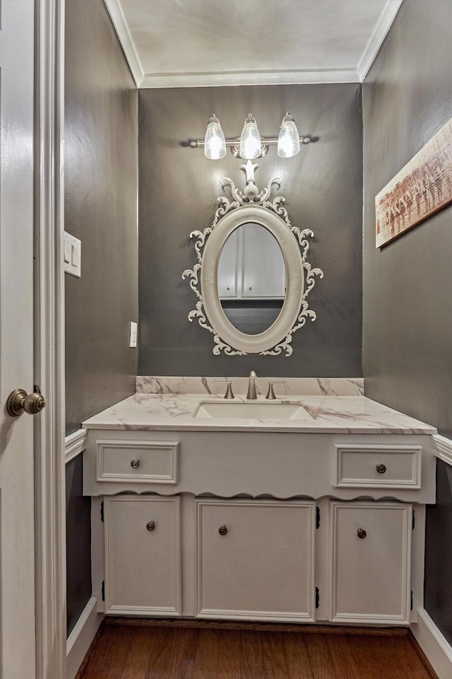 bathroom featuring crown molding, vanity, and wood finished floors