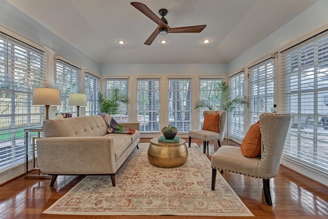 sunroom / solarium with lofted ceiling and a ceiling fan