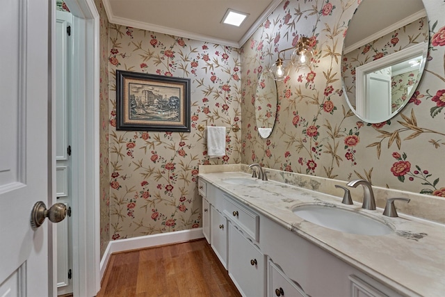 full bathroom featuring wood finished floors, a sink, and wallpapered walls