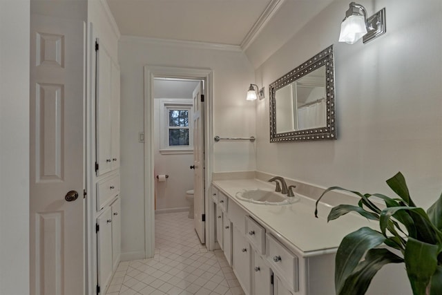 bathroom featuring toilet, ornamental molding, vanity, baseboards, and tile patterned floors