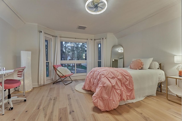 bedroom featuring ornamental molding, access to outside, visible vents, and hardwood / wood-style floors