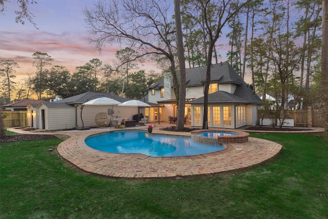 view of pool featuring a yard, a patio area, and fence