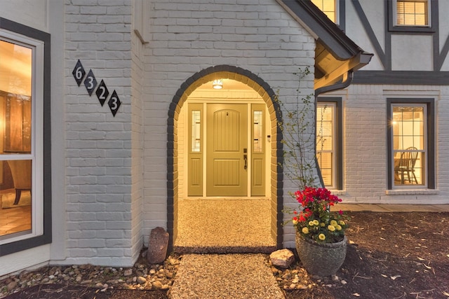 property entrance featuring brick siding