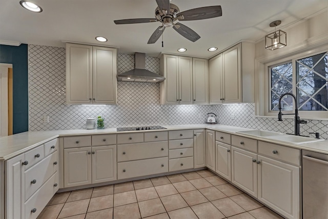 kitchen with light tile patterned floors, a sink, light countertops, stainless steel dishwasher, and wall chimney exhaust hood