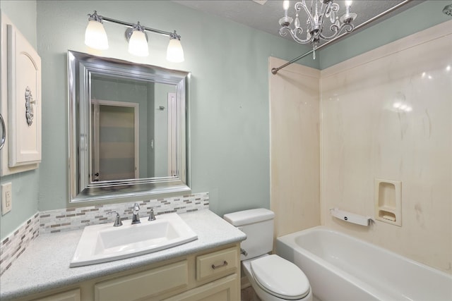 bathroom with toilet, vanity, tub / shower combination, decorative backsplash, and an inviting chandelier