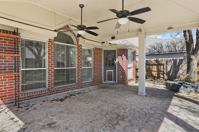 view of patio with a ceiling fan and fence