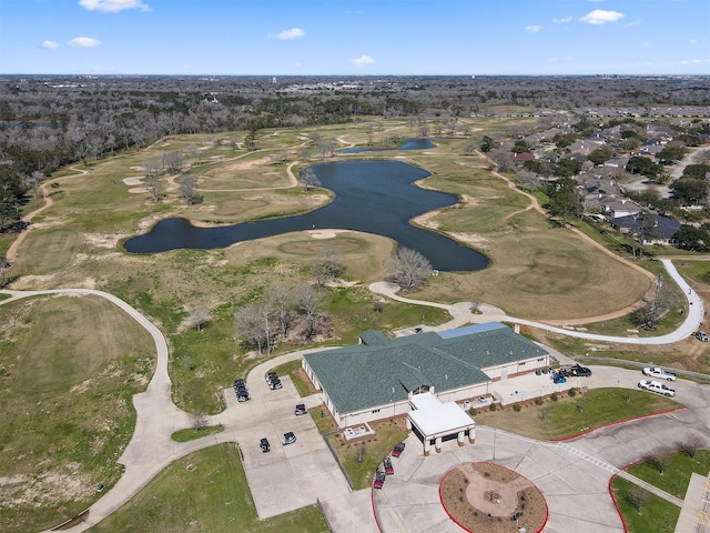 aerial view with golf course view and a water view