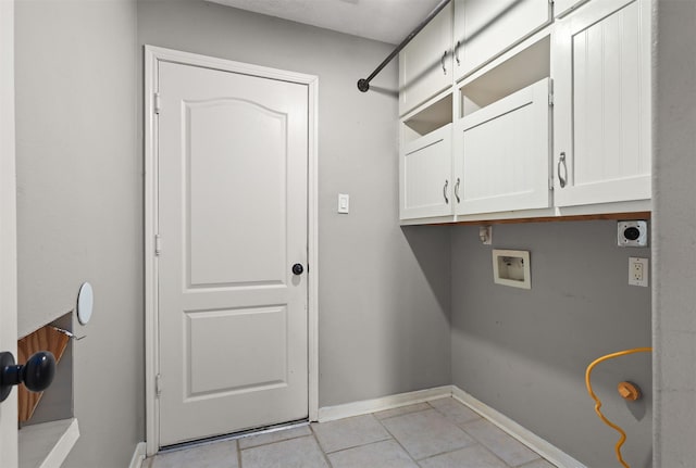 laundry room with cabinet space, baseboards, hookup for an electric dryer, washer hookup, and light tile patterned flooring