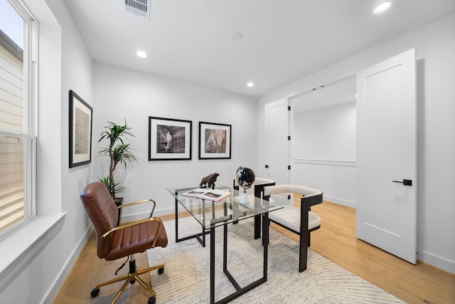 office featuring light wood-type flooring, visible vents, baseboards, and recessed lighting