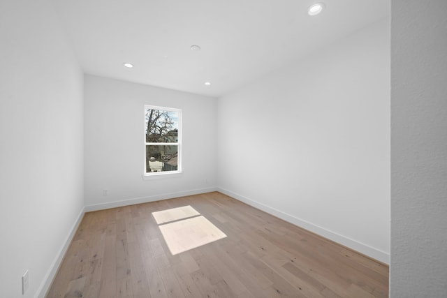 unfurnished room with recessed lighting, baseboards, and light wood finished floors