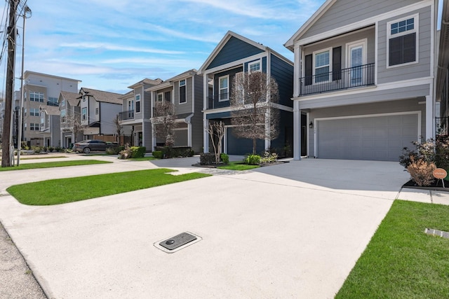 view of front of home featuring a garage, a residential view, and concrete driveway