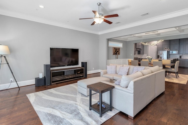 living area with dark wood-type flooring, a ceiling fan, visible vents, baseboards, and ornamental molding