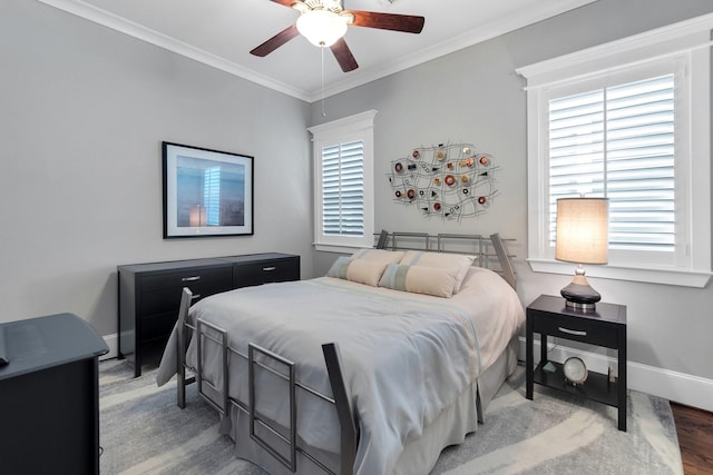 bedroom featuring a ceiling fan, baseboards, ornamental molding, and wood finished floors